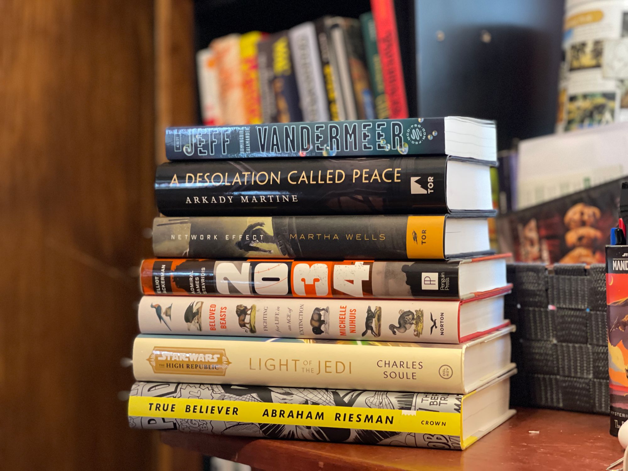 A stack of books sitting on a desk